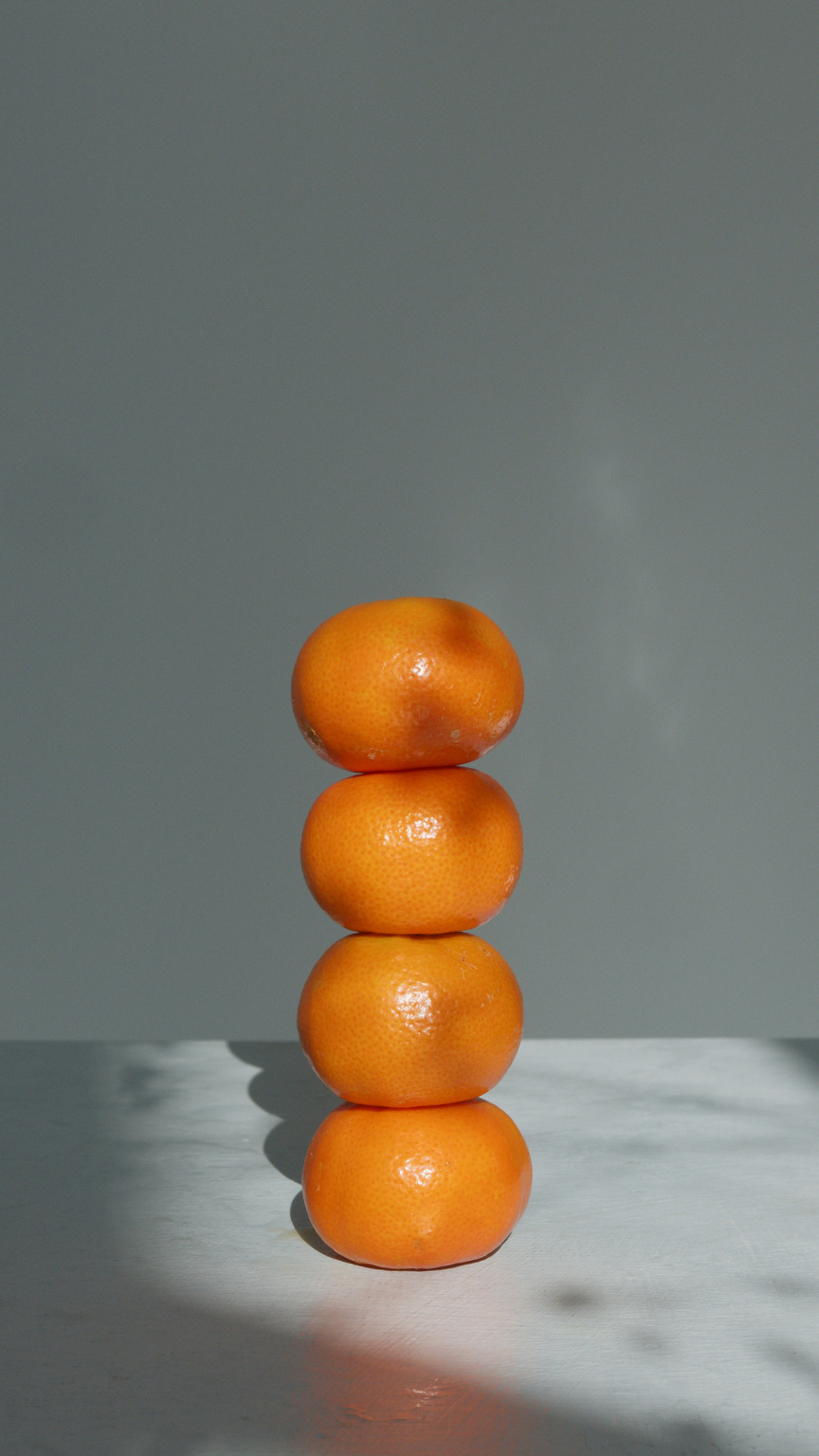 Balanced Oranges Fruit on White Table